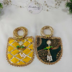 Featuring gold detailing and a decorative parrot charm, these wedding potli are perfect for bridal showers, baraati favors