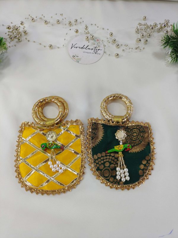 Featuring gold detailing and a decorative parrot charm, these wedding potli are perfect for bridal showers, baraati favors