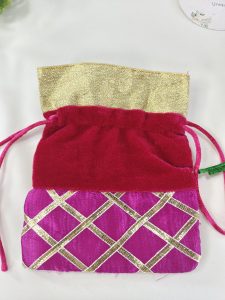Multicolor potli adorned with a golden lattice pattern, ideal for bridal accessories, wedding favors