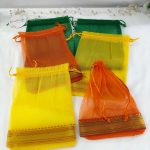 A display of beautifully crafted tissue potli bags in various colors, suitable for wedding favors, nikah ceremonies, and anniversary gifts. These bags make excellent giveaway favors