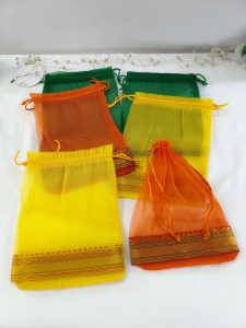 A display of beautifully crafted tissue potli bags in various colors, suitable for wedding favors, nikah ceremonies, and anniversary gifts. These bags make excellent giveaway favors