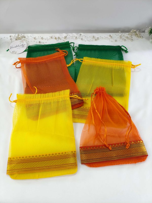A display of beautifully crafted tissue potli bags in various colors, suitable for wedding favors, nikah ceremonies, and anniversary gifts. These bags make excellent giveaway favors