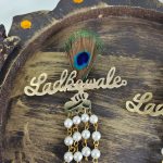 Featuring beautiful pearls and a graceful feather, this Ladkewale brooch is ideal for baaratis and groom side badges